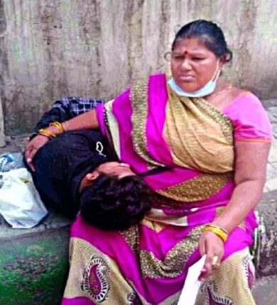 Young man lying on the ground outside OPD without treatment, mother kept pleading for treatment