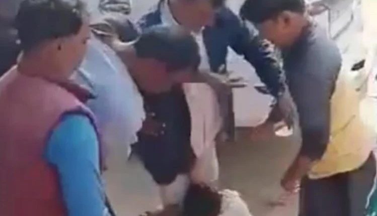 The village head and his associates beat up the Dalit youth in front of the officers.