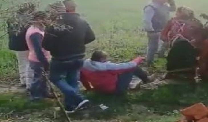 In a land dispute, the bullies beat the woman in the field