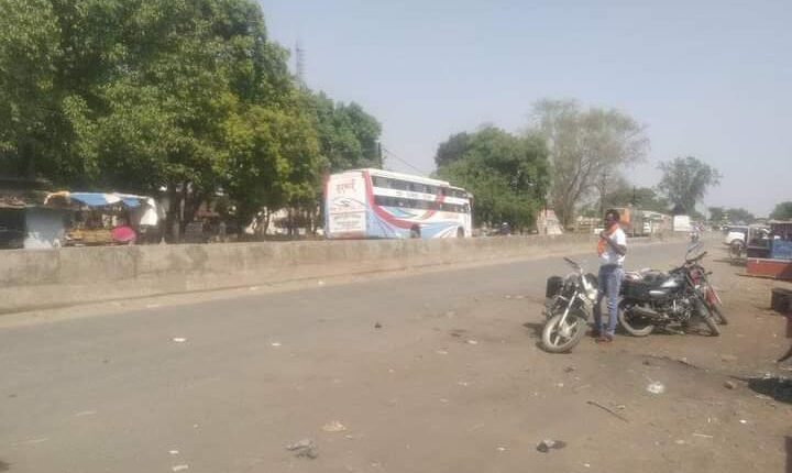 There is neither a passenger waiting room nor a shade of a tree, standing in the scorching sun, the passengers are forced to wait for the bus.