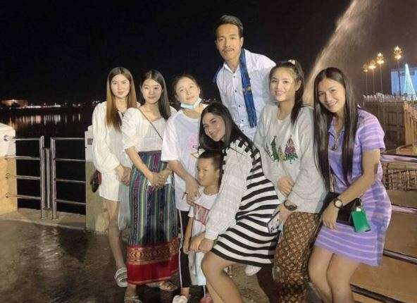 A husband who lives in the same house with his 8 wives laughingly happy