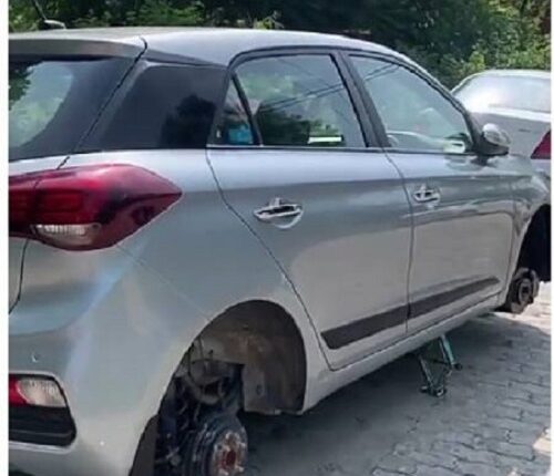 Thieves fled after stealing all four wheels of a new car parked in the society with the help of a brick