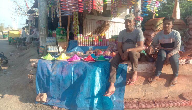 Shops decorated with Abir-Gulal in Kanchausi town. Crowd of people seen.